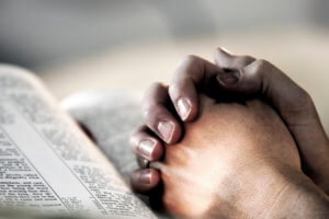 Praying-hands-with-bible