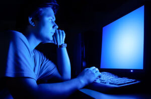 man-working-on-computer-in-the-dark
